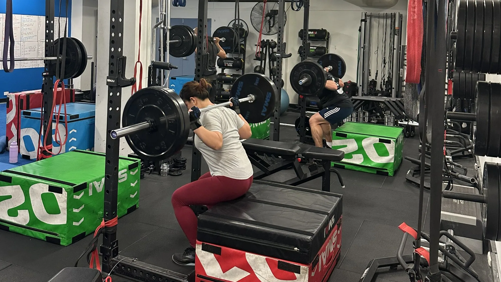 Members training with barbells