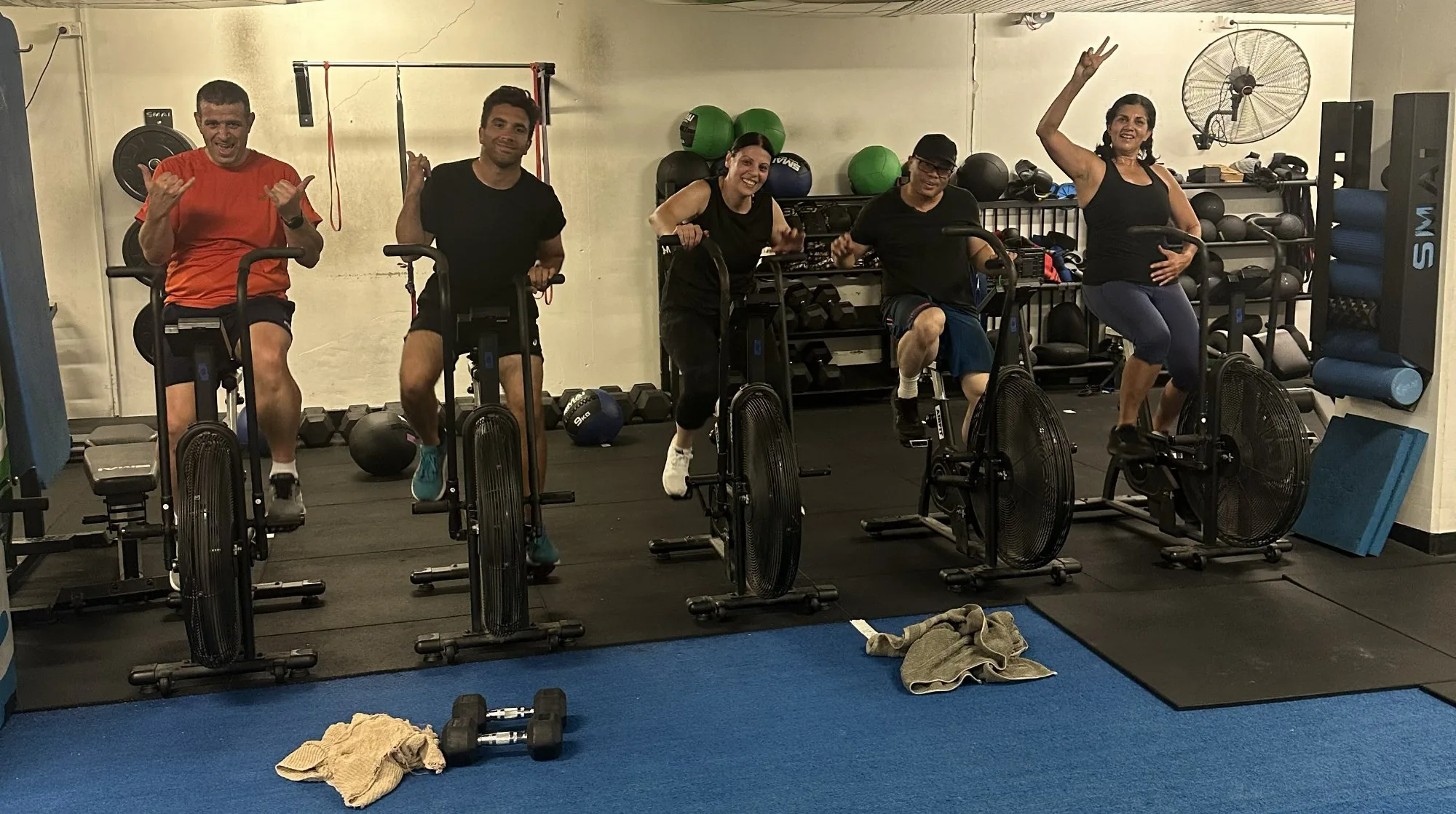 Members on assault bikes